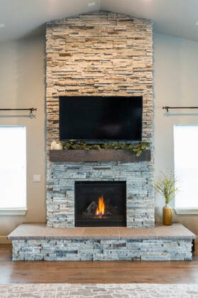 indoor dual-toned grey and beige colour stone masonry fireplace