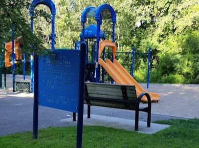 Park bench in front of playground structure in Yongehurst, Richmond Hill, Ontario